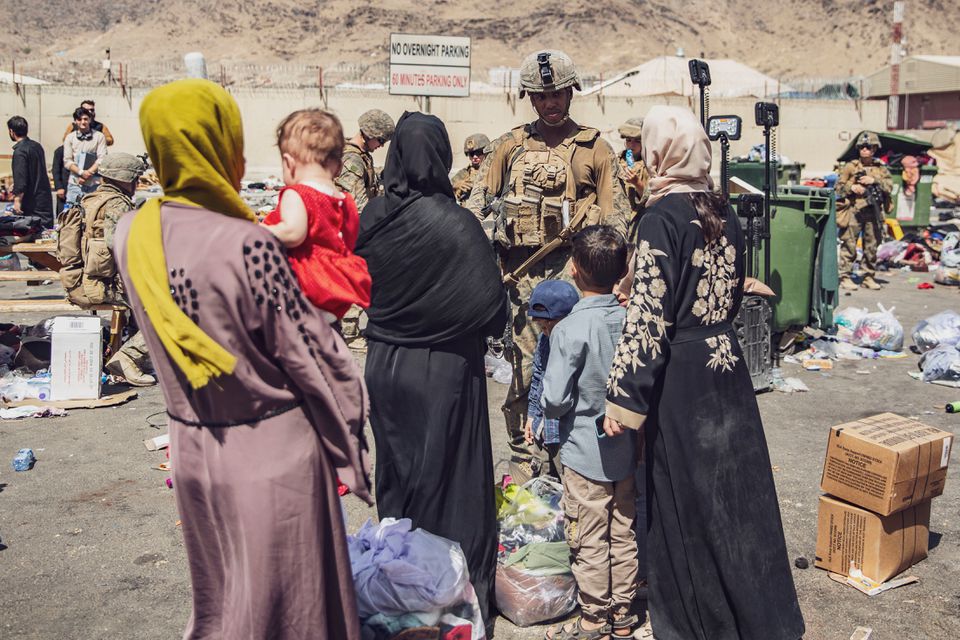 U.S. Marines with the 24th Marine Expeditionary Unit (MEU) process evacuees as they go through the Evacuation Control Center (ECC) during an evacuation at Hamid Karzai International Airport, Kabul, Afghanistan, August 28, 2021. U.S. Marine Corps/Staff Sgt. Victor Mancilla/Handout via REUTERS