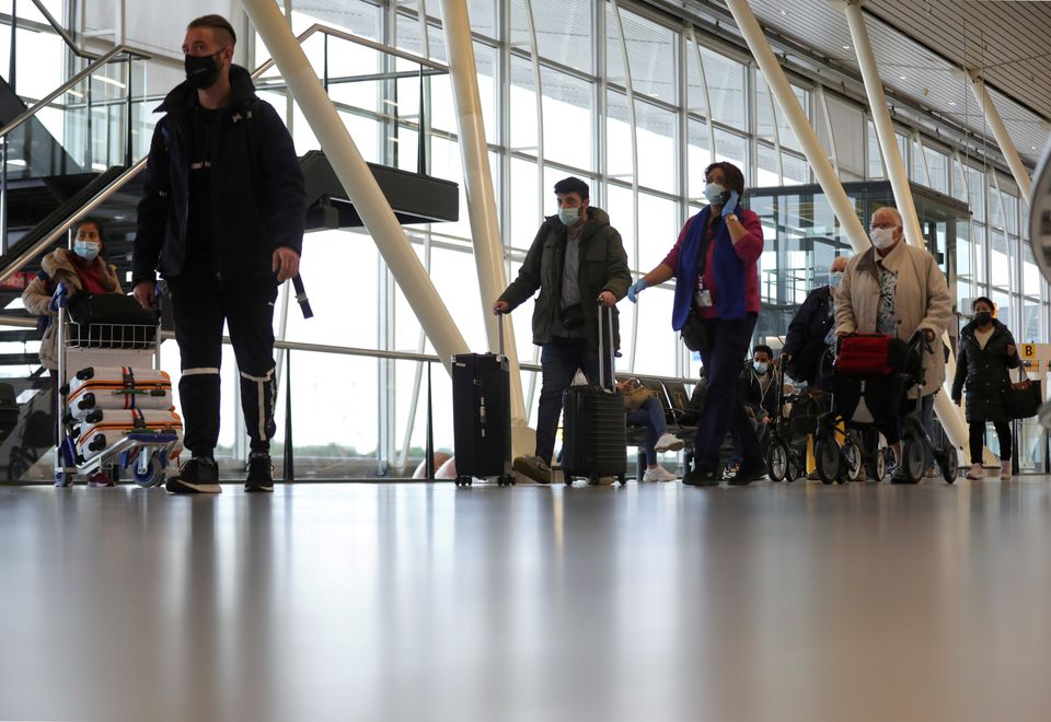People walk inside Schiphol Airport after Dutch health authorities said that 61 people who arrived in Amsterdam on flights from South Africa tested positive for COVID-19, in Amsterdam, Netherlands, November 27, 2021. REUTERS/Eva Plevier