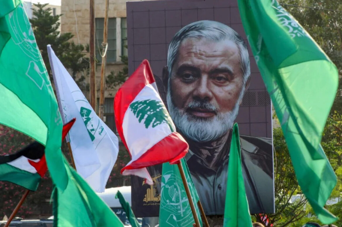 A portrait of slain Hamas leader Ismail Haniyeh is displayed during a a demonstration denouncing his killing and that Hezbollah's senior commander, in the Lebanese coastal city of Sidon. Haniyeh and a bodyguard were killed in a pre-dawn "hit" on their accommodation in Tehran on July 31, Iran's Revolutionary Guards said. Haniyeh's assassination came hours after Israel struck a southern suburb of Beirut, killing Fuad Shukr, the military commander of Lebanese Hamas ally Hezbollah. -AFP/Mahmoud ZAYYAT